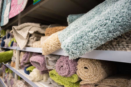 Bath mat assortment on a store counter close up background.の写真素材