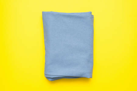 Blue tissue on the yellow flat lay background.の写真素材
