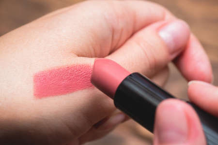 Woman is choosing a new lipstick concept.の写真素材