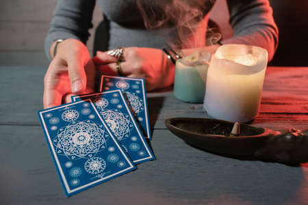 Fortune teller is reading a future by tarot cards.の写真素材