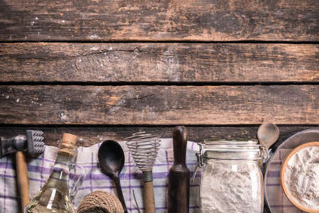 Old rural kitchen utensils on the old wooden rural table background with copy space.の写真素材
