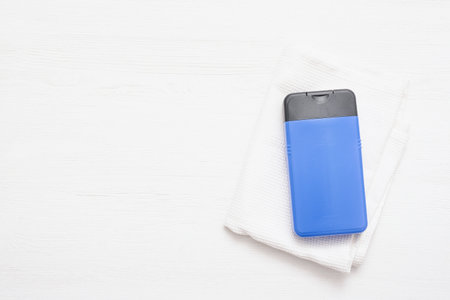 Shower gel bottle and white towel on the white wooden table background top view.の写真素材