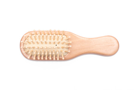 Wooden hair comb isolated on the white background.の写真素材
