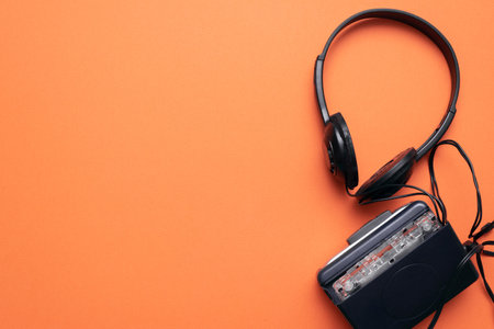 Old retro stereo cassette player and headphones on the orange flat lay background.の写真素材