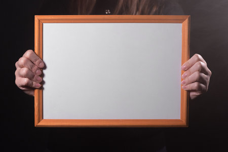 A blank diploma certificate in the female hands close up.の写真素材