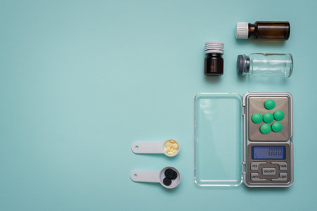 Tablets, medical bottles and small electronic weights on the blue background. Pharmacology.の写真素材