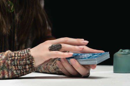 Fortune teller is reading the future with tarot cards close up.