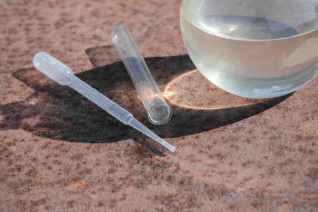 A dirty water of the garden well in the laboratory flask. Water pollution.の写真素材