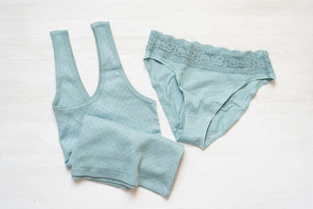 Mint color female shirt and panties on the white table background.の写真素材