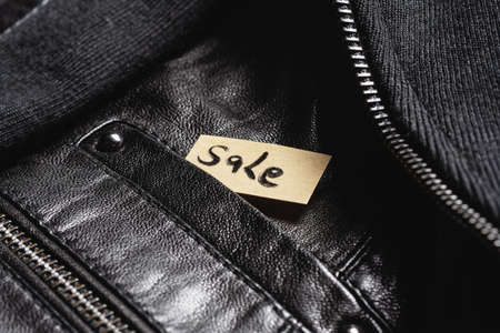 Sale tag label in the clothes pocket close up background. Discount concept.の写真素材