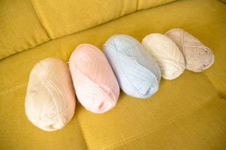 Balls of woolen threads on the sofa. Knitting background.の写真素材