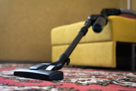 Vacuum cleaner on the carpet in the living room.の写真素材