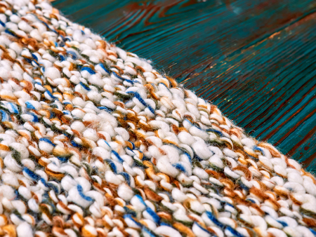 Knitted product carpet plaid close up of fiber of thread texture wool wooden background board floor...