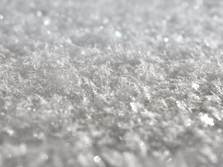 texture of white snow sparkling in the sun macroの写真素材