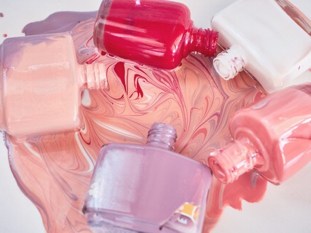 Group of bright nail polishes, on wooden colour background.の写真素材