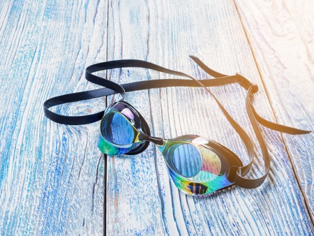 Accessories for sports swimming on wooden background sunshineの写真素材