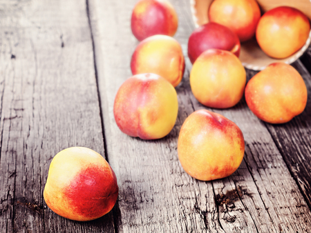 Fresh ripe nectarine peach, crop harvest rustic background, healthy, organic, diet fruit food, slice with stone, full fruitの写真素材