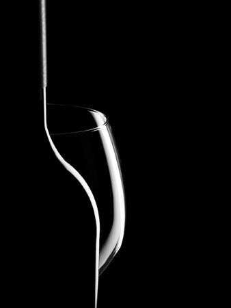 Elegant silhouette bottle of wine and glass on black backgroundの写真素材
