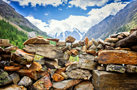 Picturesque landscape, handmade wall of stone on river bank dawn sunrise backpacking against background of high mountain, wild nature, ecological tourism, Mountain Altai Russiaの写真素材