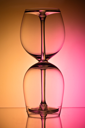 Two empty wineglass for red wine on diffusion lit background in abstract 
 composition with reflection, advertizing shot for restaurant, winemakingの写真素材