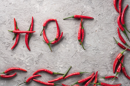 Chili Pepper inscription Hot spicy spices on gray stone concrete background tableの写真素材