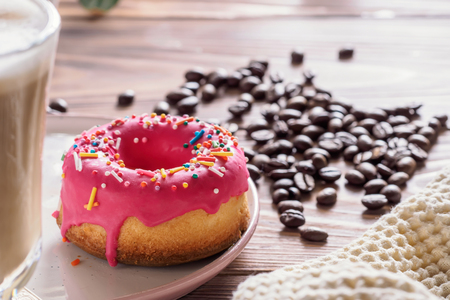 Cup of hot coffee latte beverages with donut glazedの写真素材