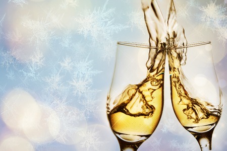 Two elegant glasses with sparkling champagne with splash. Holiday card Christmas, New Year, wedding. Celebration concept with effects of bokeh, frost frozen snowflakes, advertising designの写真素材