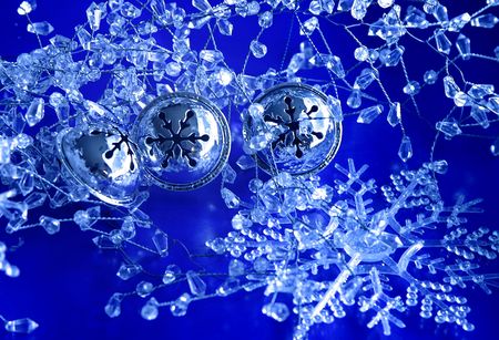 Three silver bells in snow and ice decorationsの写真素材