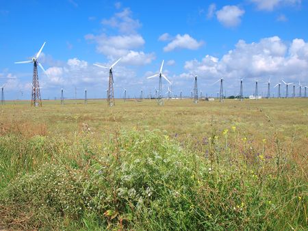 Wind power stations on the summer green field against cloudy sky. Crimea, Ukraine         の写真素材