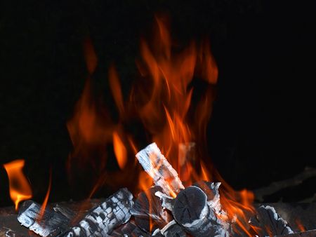 Camp-fire flames with firewoods late in the evening.            の写真素材