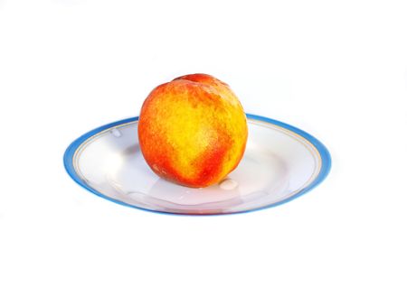 Tasty fresh peach on a plate on a white background with drops of water. Healthy food の写真素材