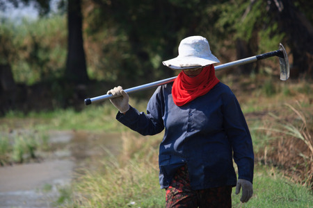 Thai farmer carrying hoeの写真素材