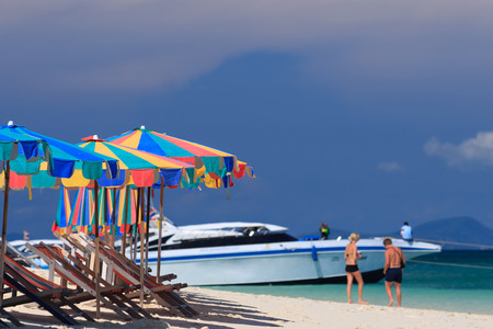 Beach chairs and parasol on Koh Khai island. Phuket, Thailand.の写真素材