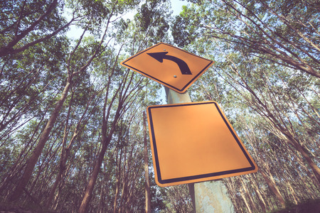 Traffic sign against rubber trees background in Koh Yao Noi , Phang Nga, THAILAND. Vintage color style.の写真素材