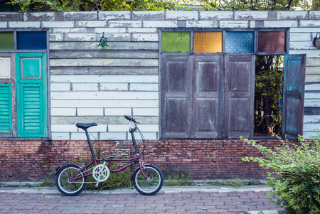 Folding Bike with old wooden wall, Vintage color.の写真素材