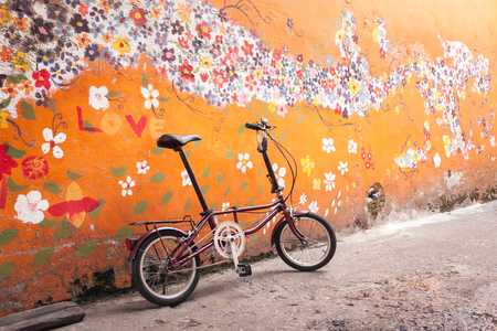 Folding Bike with old wall, Vintage color.の写真素材