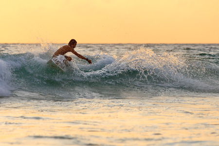 Surfer on the beach at Kata beach, Phuket, Thailand.の写真素材