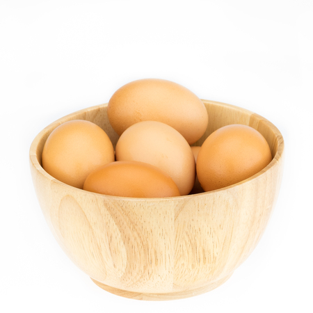 Eggs with wooden cup isolated on white background.の写真素材
