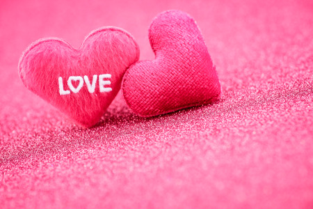 Valentine hearts with the word "love" on abstract background.の写真素材