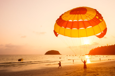 Silhouette of Parasailing at Kata beach with sunset background, Phuket, Thailand.の写真素材