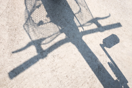 Shadow of bicycle on the ground.の写真素材
