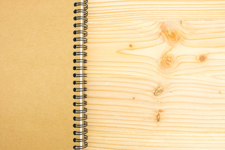 Brown blank notebook on wooden table background.の写真素材