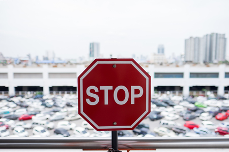 Stop sign against car parking background.の写真素材