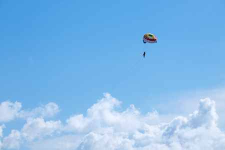 Parasailing against a blue sky and cloud.の写真素材