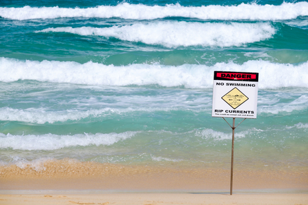 No swimming warning sign on the beach.の写真素材
