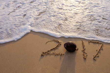 2017 written on sand beach.