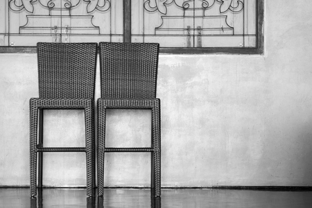 Wood weave chair with windows and wall background. Black and White tone.の写真素材