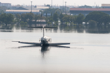 Airplane  on a flooded section of Airport in Bangkok. Thailand.