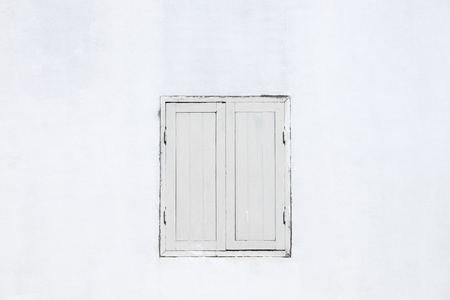 Old white window on white wooden wall.の写真素材