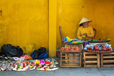 HOI AN, VIETNAM - MARCH 02, 2017:  local Vietnamese women street vendor in Hoi An Ancient Town, Vietnam.のeditorial素材